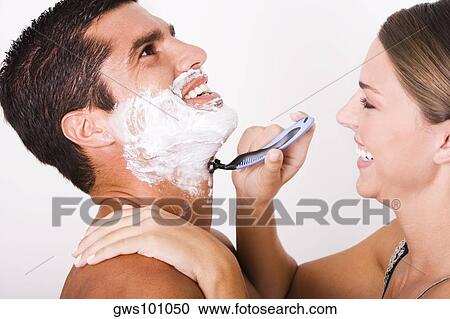 Side profile of a young woman shaving a mid adult man View Large Photo Image Stock Image - Side profile of a young woman shaving a mid adult man. Fotosearch