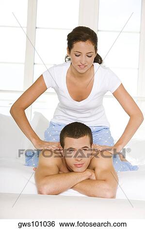 Young woman massaging a young man's shoulders View Large Photo Image Stock Photograph - Young woman massaging a young man's shoulders. Fotosearch