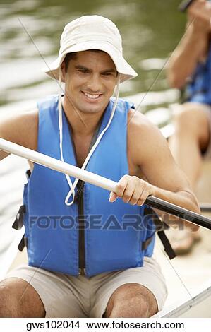 Close-up of a mid adult man holding an oar View Large Photo Image Picture - Close-up of a mid adult man holding an oar. Fotosearch