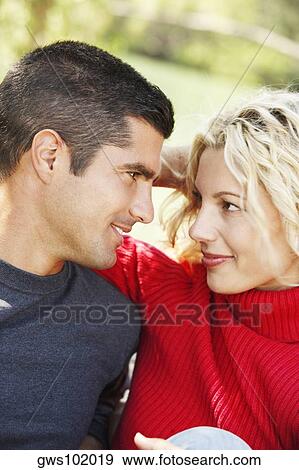 Stock Photo - Close-up of a mid adult man looking at a young woman. Fotosearch