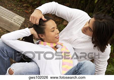 Close-up of a young woman lying on a young man's lap View Large Photo Image Stock Photograph - Close-up of a young woman lying on a young man's lap. Fotosearch