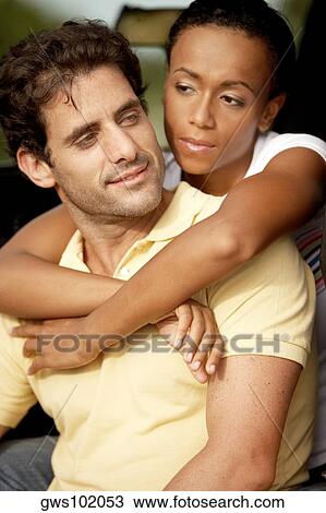 Close-up of a young woman wit her arms around a mid adult man View Large Photo Image Stock Image - Close-up of a young woman wit her arms around a mid adult man. Fotosearch
