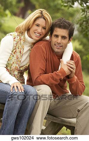 Close-up of a young woman's arm around a mid adult man View Large Photo Image Picture - Close-up of a young woman's arm around a mid adult man. Fotosearch