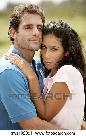 Mid adult man embracing a young woman View Large Photo Image Stock Image - Mid adult man embracing a young woman. Fotosearch