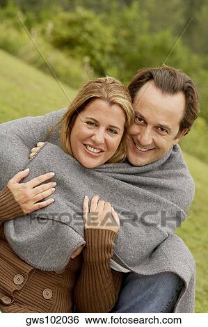 Portrait of a mature man embracing a mid adult woman View Large Photo Image Stock Photograph - Portrait of a mature man embracing a mid adult woman. Fotosearch