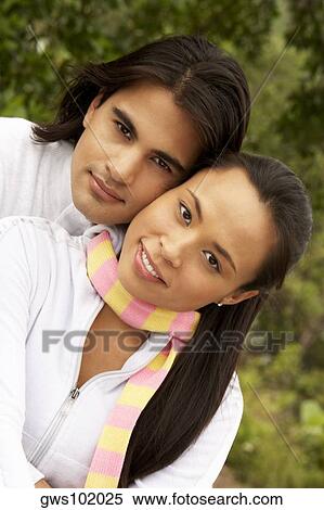 Portrait of a young man embracing a young woman from behind View Large Photo Image Stock Photography - Portrait of a young man embracing a young woman from behind. Fotosearch