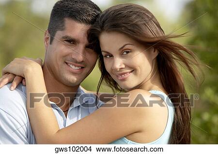 Portrait of a young woman and a mid adult man smiling View Large Photo Image Picture - Portrait of a young woman and a mid adult man smiling. Fotosearch