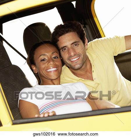 Portrait of a young woman and a mid adult man sitting in a jeep View Large Photo Image Stock Photograph - Portrait of a young woman and a mid adult man sitting in a jeep. Fotosearch