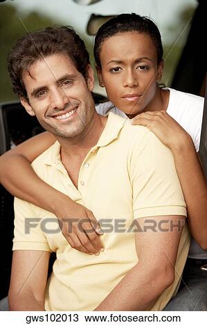 Portrait of a young woman with her arms around a mid adult man View Large Photo Image Stock Image - Portrait of a young woman with her arms around a mid adult man. Fotosearch