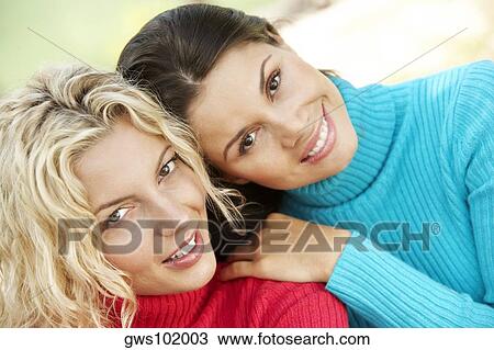 Portrait of two young women smiling View Large Photo Image Stock Image - Portrait of two young women smiling. Fotosearch