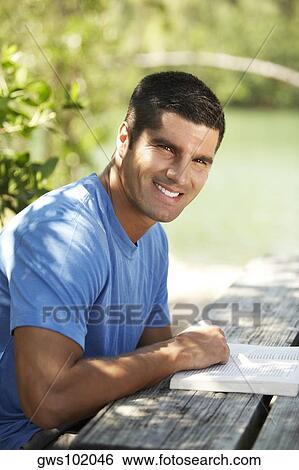 Stock Photograph - Side profile of a mid adult man smiling. Fotosearch