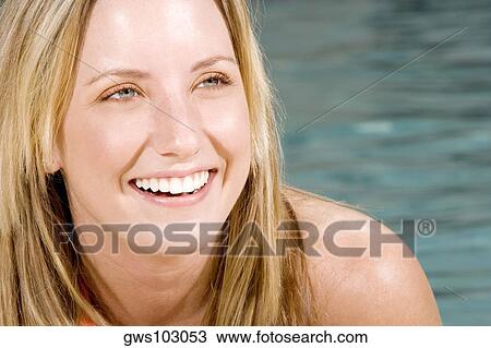 Close-up of a young woman smiling View Large Photo Image Stock Image - Close-up of a young woman smiling. Fotosearch