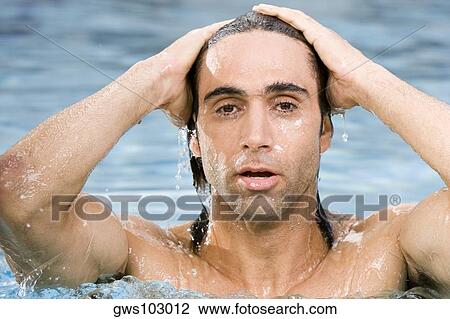 Portrait of a mid adult man swimming in a swimming pool View Large Photo Image Stock Image - Portrait of a mid adult man swimming in a swimming pool. Fotosearch