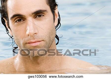 Portrait of a mid adult man swimming in a swimming pool View Large Photo Image Stock Photograph - Portrait of a mid adult man swimming in a swimming pool. Fotosearch