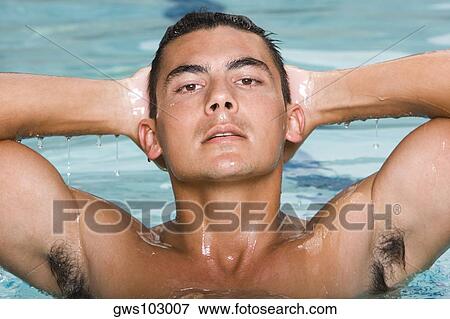 Portrait of a young man in a swimming pool View Large Photo Image Stock Photo - Portrait of a young man in a swimming pool. Fotosearch