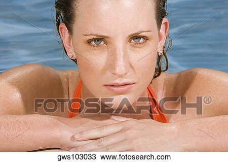 Portrait of a young woman leaning at the edge of a swimming pool View Large Photo Image Stock Image - Portrait of a young woman leaning at the edge of a swimming pool. Fotosearch