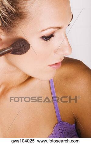 Close-up of a young woman applying blush with a brush View Large Photo Image Stock Photography - Close-up of a young woman applying blush with a brush. Fotosearch