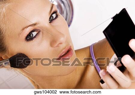 Portrait of a young woman applying blush with a brush View Large Photo Image Stock Image - Portrait of a young woman applying blush with a brush. Fotosearch
