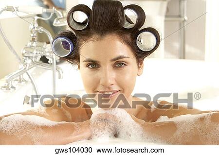Portrait of young woman with curlers in her hair in a bathtub View Large Photo Image Stock Image - Portrait of young woman with curlers in her hair in a bathtub. Fotosearch