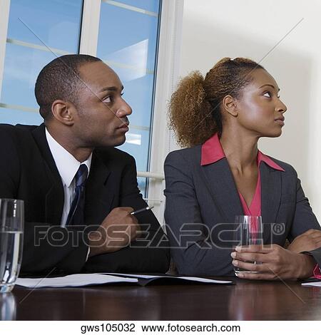 Close-up of a businessman and a businesswoman in an office View Large Photo Image Stock Image - Close-up of a businessman and a businesswoman in an office. Fotosearch