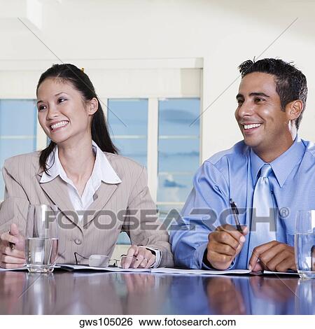 Stock Photograph - Close-up of a businessman and a businesswoman in an office. Fotosearch