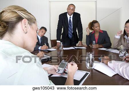 Stock Image - Group of business executives in a meeting. Fotosearch