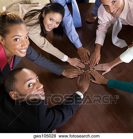 High angle view of a group of business executives with their hands on a table View Large Photo Image Stock Photo - High angle view of a group of business executives with their hands on a table. Fotosearch