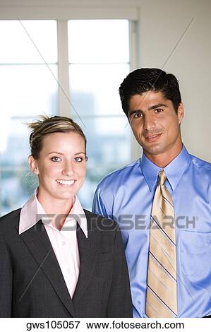 Stock Photo - Portrait of a businessman and a businesswoman smiling. Fotosearch