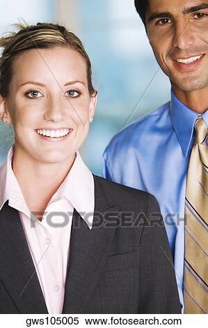 Stock Photography - Portrait of a businessman and a businesswoman smiling. Fotosearch