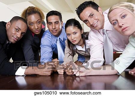 Portrait of a group of business executives with their fists on a table View Large Photo Image Stock Image - Portrait of a group of business executives with their fists on a table. Fotosearch
