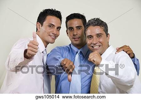 Picture - Portrait of three businessmen gesturing thumbs up. Fotosearch