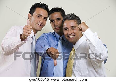 Stock Photography - Portrait of three businessmen gesturing thumbs up. Fotosearch