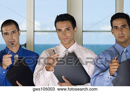 Portrait of three businessmen holding pens View Large Photo Image Stock Image - Portrait of three businessmen holding pens. Fotosearch