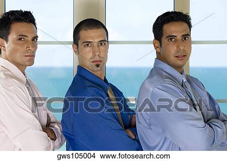 Picture - Portrait of three businessmen standing in a row. Fotosearch