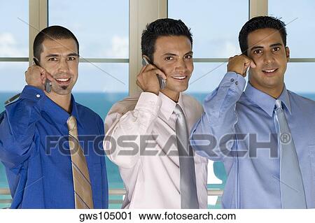 Portrait of three businessmen using mobile phones View Large Photo Image Stock Image - Portrait of three businessmen using mobile phones. Fotosearch