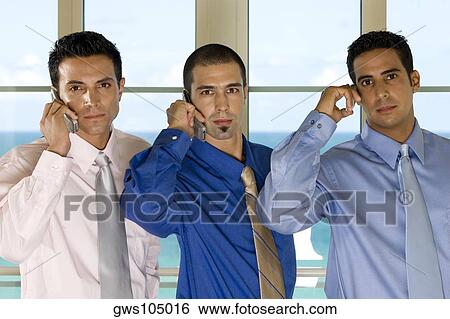 Portrait of three businessmen using mobile phones View Large Photo Image Stock Photograph - Portrait of three businessmen using mobile phones. Fotosearch