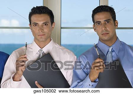 Portrait of two businessmen holding pens View Large Photo Image Stock Image - Portrait of two businessmen holding pens. Fotosearch