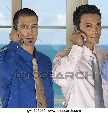 Portrait of two businessmen using mobile phones View Large Photo Image Stock Photography - Portrait of two businessmen using mobile phones. Fotosearch