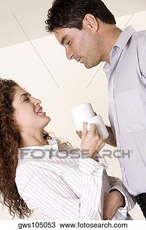 Side profile of a young woman and a mid adult man holding coffee cups View Large Photo Image Stock Image - Side profile of a young woman and a mid adult man holding coffee cups. Fotosearch