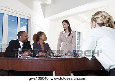 Three businesswomen and a businessman in an office View Large Photo Image Stock Image - Three businesswomen and a businessman in an office. Fotosearch