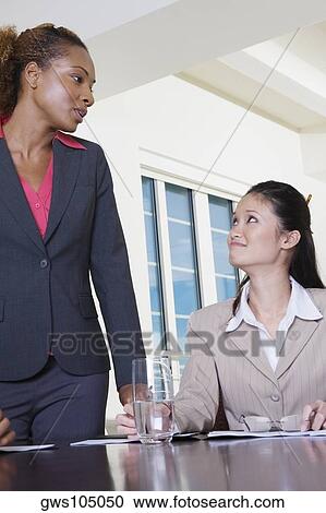 Two businesswomen in an office View Large Photo Image Stock Image - Two businesswomen in an office. Fotosearch