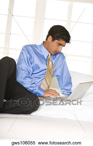 Businessman working on a laptop View Large Photo Image Stock Photography - Businessman working on a laptop. Fotosearch