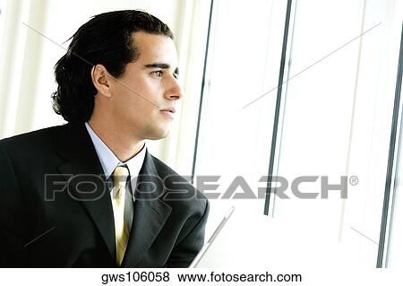 Close-up of a businessman looking away View Large Photo Image Stock Photo - Close-up of a businessman looking away. Fotosearch