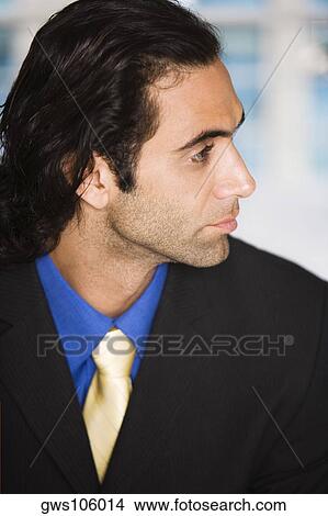 Close-up of a businessman looking sideways View Large Photo Image Picture - Close-up of a businessman looking sideways. Fotosearch