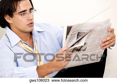 Close-up of a businessman reading a newspaper View Large Photo Image Stock Image - Close-up of a businessman reading a newspaper. Fotosearch