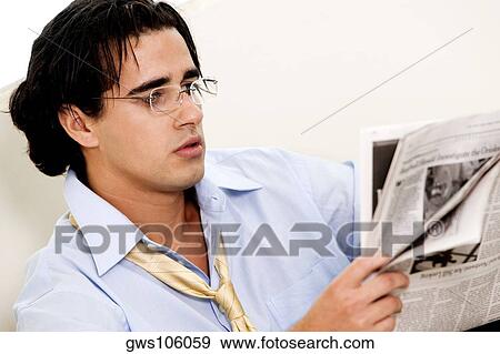 Close-up of a businessman reading a newspaper View Large Photo Image Stock Photo - Close-up of a businessman reading a newspaper. Fotosearch