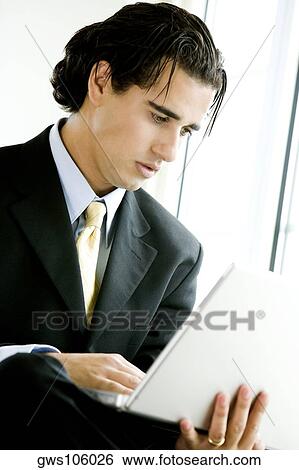 Close-up of a businessman using a laptop View Large Photo Image Stock Photograph - Close-up of a businessman using a laptop. Fotosearch