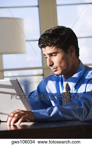 Close-up of a businessman working on a laptop View Large Photo Image Picture - Close-up of a businessman working on a laptop. Fotosearch