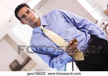 Portrait of a businessman holding a glass of wine View Large Photo Image Stock Image - Portrait of a businessman holding a glass of wine. Fotosearch