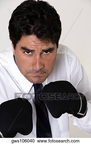 Portrait of a businessman wearing boxing gloves View Large Photo Image Stock Image - Portrait of a businessman wearing boxing gloves. Fotosearch